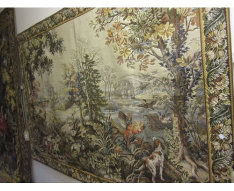 Machine woven tapestry wall hanging depicting a landscape within a floral border, 7ft x 5ft approximately