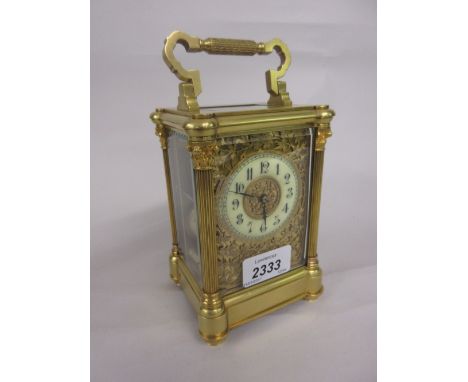 Early 20th Century gilt brass cased carriage clock, the moulded case with fluted Corinthian corner pilasters enclosing a gilt