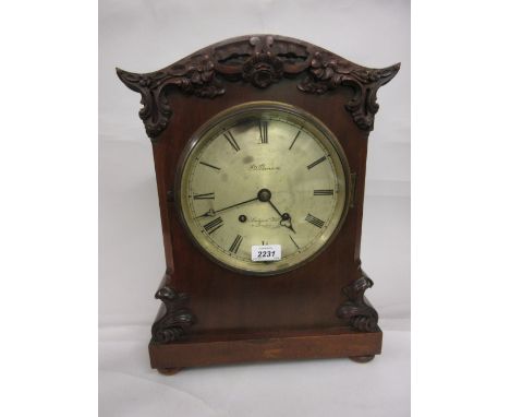 Late 19th or early 20th Century mahogany bracket clock with carved applied decoration the circular silvered dial with Roman n