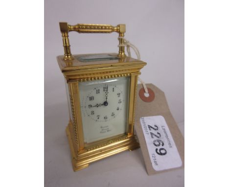 Miniature gilt brass cased carriage clock, the enamel dial with Arabic numerals, signed Racine, Dublin ' Paris Made '