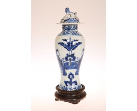 A CHINESE KANGXI STYLE SLENDER BALUSTER VASE AND COVER, late 19th Century, decorated with figures in a garden, the cover with