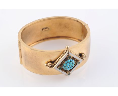 A MID VICTORIAN TURQUOISE AND ENAMEL BANGLE, set to the centre with a raised square mount with beaded detailing and subtle wh