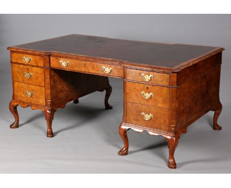 A HANDSOME BURR WALNUT PARTNERS DESK, EARLY 20TH CENTURY, the inverted breakfront top with tooled leather writing surface abo