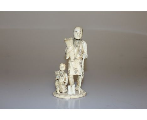 A JAPANESE IVORY SECTIONAL OKIMONO, MEIJI PERIOD, modelled as a man holding a bunch of flowers and a stick, with a child by h