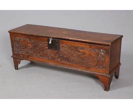 AN OAK AND ELM SIX PLANK CHEST, with moulded top and carved front, raised on bracket feet. 48.5cm by 118.5cm by 33.5cm.