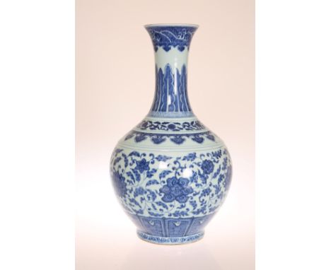 A CHINESE BLUE AND WHITE FLORAL BOTTLE VASE, decorated in the Ming style with lotus flowers within a foliate scroll ground, s