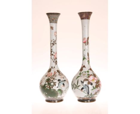 A PAIR OF JAPANESE CLOISONNE ENAMEL BOTTLE VASES, each decorated with birds on blossoming boughs, Meiji period. 31cm