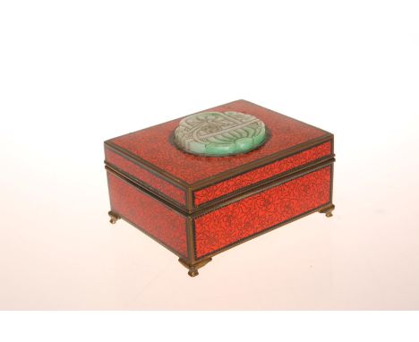 A JAPANESE ENAMEL BOX, EARLY 20th CENTURY, in red and gilt enamel, the hinged cover inset with a carved circular plaque, prob