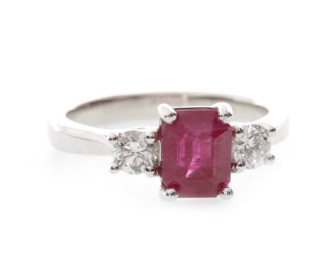 RUBY AND DIAMOND THREE STONE RING, set with a central step cut ruby of approximately 1.86 carats, flanked by two round brilli