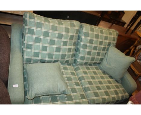 A GREEN UPHOLSTERED SOFA BED