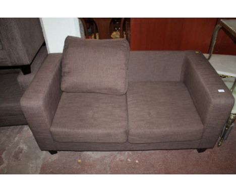 A MODERN UPHOLSTERED TWO SEATER SOFA