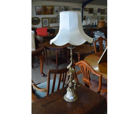 A cast metal and marble figural based table lamp