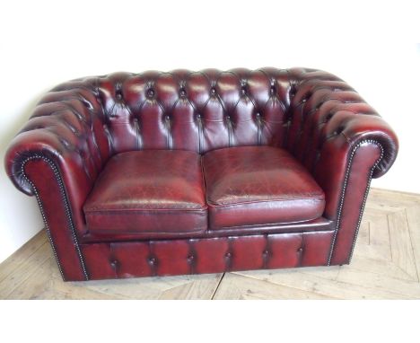 Red leather two seater Chesterfield style sofa 