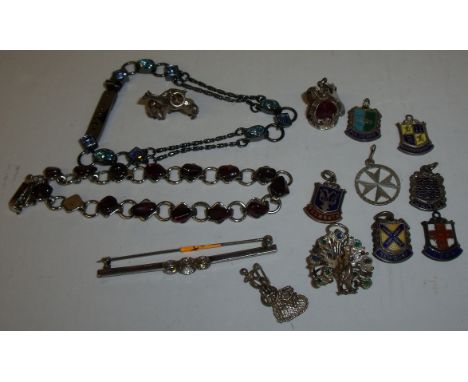 Small selection of silver and enamel fobs, bar brooch set with three clear stones, bracelets etc.