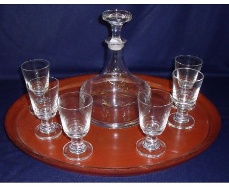 Squat glass decanter and a set of six glasses on oval paper mache tray