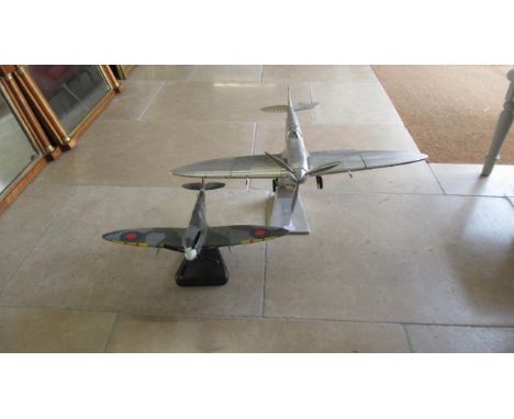 A large scale model of a Spitfire and one smaller painted example - size nose to tail 60cm and wingspan 75cm 