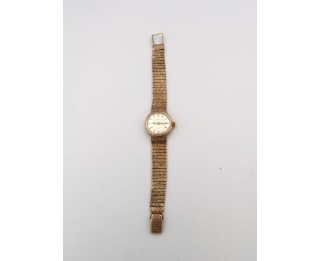 A 9ct gold Eterna-Matic Sahida wrist watch with bark effect articulated bracelet. Weight 31.67 grams. Condition - fair with o