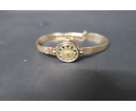A ladies 9ct yellow gold cased Rotary watch with gold face and baton markers on 9ct gold bracelet strap, total weight approx 