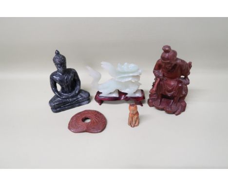 An Oriental jade carved dragon on a wooden base, 10cm long x 9.5cm high, a carved wooden figure of an Oriental gentleman hold