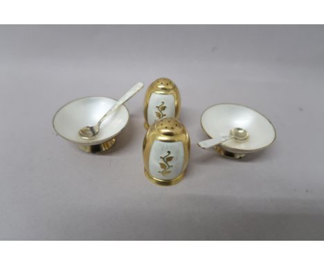Two Volmer Bahner (Danish), (1912-1995) Gilded silver salt and pepper set, the salts decorated with white enamel with spoons,