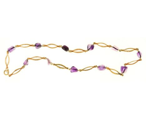 AN AMETHYST BEAD NECKLACE, IN TEXTURED GOLD MARKED 585, 14G++IN GOOD CONDITION, WITH LIGHT WEAR CONSISTENT WITH AGE