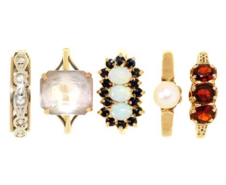 FIVE GEM SET GOLD RINGS, INCLUDING A THREE STONE GARNET RING, AND A THREE STONE OPAL AND SAPPHIRE RING, HALLMARKED OR MARKED 