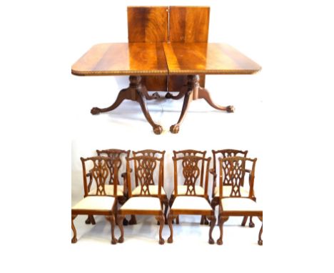 A Georgian style carved mahogany triple pillar extending dining table with two extra leaves, 20th Century
Rectangular top wit