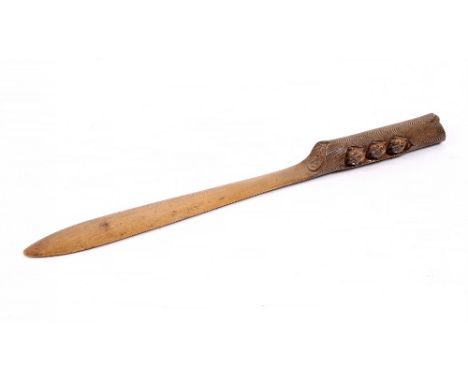 A 19TH CENTURY CONTINENTAL CARVED WOODEN PAGE TURNER the handle in the form of a short piece of tree branch with three small 