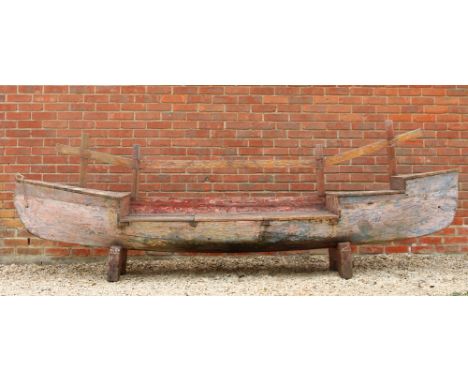 A PAINTED WOODEN CANOE BENCH with lifting lid to the box seat, 340cm long x 55cm deep x 110cm high