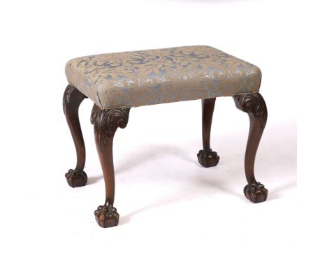 A GEORGIAN STYLE MAHOGANY STOOL with overstuffed upholstered seat and with acanthus leaf carved decoration to the cabriole le