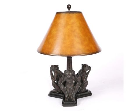 A BRONZED TABLE LAMP with conical shade, the base set with three monkeys, 67cm high