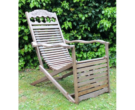 AN ORIENTAL HARDWOOD FOLDING STEAMER TYPE CHAIR with slatted seat, 62cm wide 