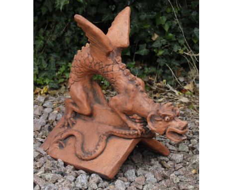 A 20TH CENTURY TERRACOTTA ROOF RIDGE TILE surmounted by a dragon on a 'V' ridge tile, 46cm long x 44cm high