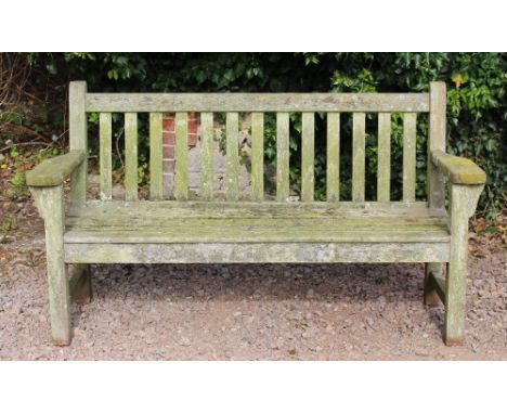 AN OLD TEAK GARDEN BENCH with flat arms and slatted back and seat, 61cm wide