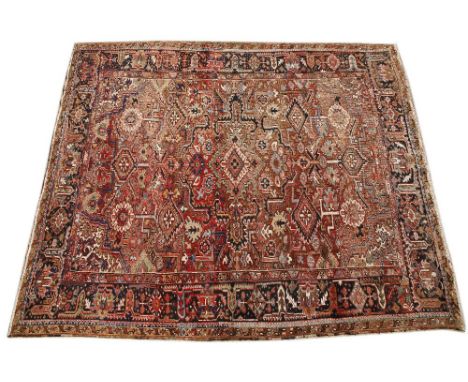 A RED AND BLUE GROUND SMALL CARPET with geometric decoration and a banded border, 305cm x 360cm