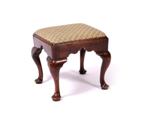 AN EARLY 18TH CENTURY ELM FOOTSTOOL with tapestry seat, standing on cabriole legs, 40cm x 38cm x 38cm