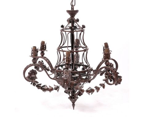A PAIR OF RED PAINTED WROUGHT IRON SIX LIGHT ELECTROLIERS with scrolling branches and decorated with roses and floral swags, 