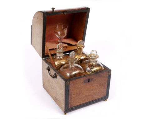 A GEORGIAN MAHOGANY DECANTER BOX consisting of four decanters with hand painted gilt decoration and a matching drinking glass