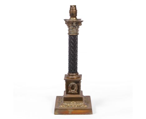 A VICTORIAN BRASS AND EBONY OIL LAMP BASE of Corinthian column form, later converted for use as an electric table lamp, with 