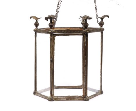 A GEORGIAN STYLE BRASS HEXAGONAL HALL LANTERN with eagle finials and fluted column decoration to each corner 35.5cm high 