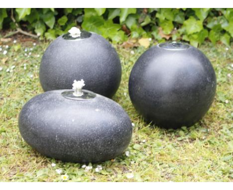 A PAIR OF CAST COMPOSITE SPHERICAL OIL LAMPS each 18cm high together with a further similar oil lamp of ovoid form, 23cm wide