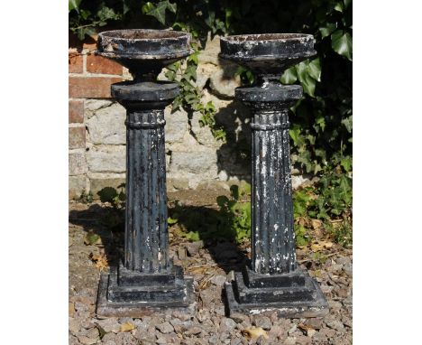 A PAIR OF BLACK PAINTED CAST IRON EXTERNAL LAMP FITTINGS with fluted columns and square bases, 20.5cm wide x 58cm high