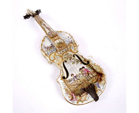 A DECORATIVE CONTINENTAL POTTERY VIOLIN decorated with scenes of children playing, 60cm long overall
