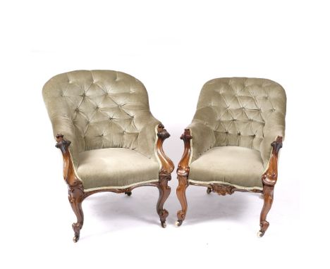 TWO VICTORIAN ROSEWOOD BUTTON UPHOLSTERED ARMCHAIRS with scroll carved arm supports and cabriole legs, one slightly larger th