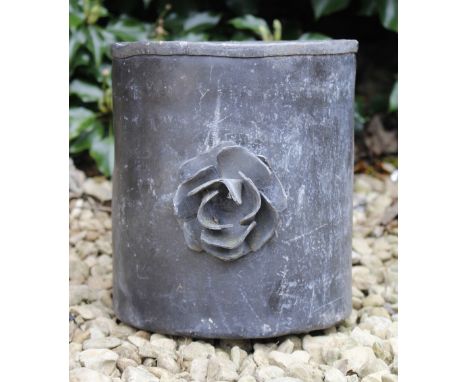 A LEAD PLANTER  with applied flower decoration, 23cm high