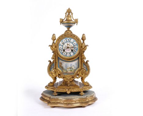 A CONTINENTAL GILT METAL MANTLE CLOCK the case with urn and acorn finials, scrolling mounts, paw feet, decorated with coloure