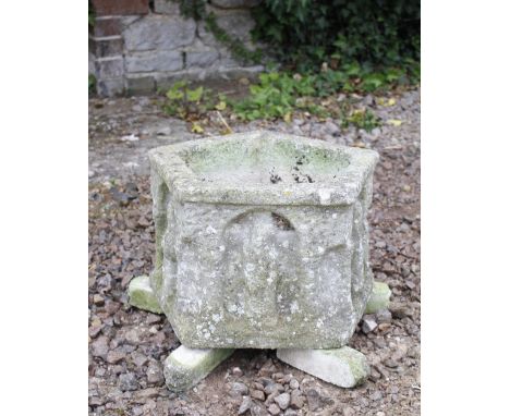 AN ANTIQUE PENTAGONAL STONE PLANTER  depicting saints, 46cm wide x 30cm high