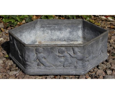 AN OCTAGONAL SHALLOW LEAD PLANTER the outside decorated with putti, 37cm wide x 12cm high