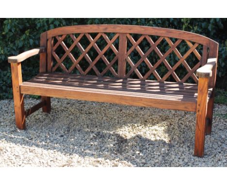 A TEAK GARDEN BENCH  with a lattice back and a slatted seat, 157cm wide