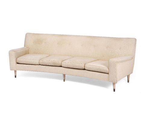 A MID 20TH CENTURY CREAM UPHOLSTERED CURVED SOFA in the manner of Gio Ponti with button upholstered back, limed turned taperi